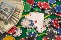 US Dollars play card and poker chips on a gaming table Royalty Free Stock Photo