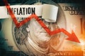 Inflation word under the torn dollar bill. Economist forecast for the United States. Glowing red arrow going downwards on Benjami