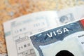 US Embassy visa in passport page with stamps on office table Royalty Free Stock Photo