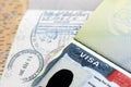 US Embassy visa in passport page with stamps on office table Royalty Free Stock Photo