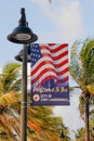 US flag on Fort Lauderdale's beach picturesque palm trees in the background, Florida, USA Royalty Free Stock Photo