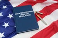 On the US flag lies a pen and a book with the inscription - COUNTERTERRORISM LAWS AND REGULATIONS