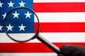 US flag looking through a magnifying glass. Study of the history and culture of the country of the United States. The concept of Royalty Free Stock Photo