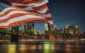 US flag New York City& x27;s Brooklyn Bridge and Manhattan skyline illuminated Royalty Free Stock Photo