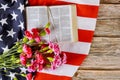 US flag with praying over a open reading Holy Bible on a close up of america pray