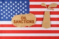 On the US flag there is an oil rig cut out of cardboard and a sign with the inscription - Oil sanctions
