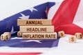 On the US flag and wooden plates with the inscription - Annual headline inflation rate