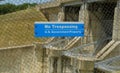 US government no trespassing sign posted om wired fence limiting access to a dam Royalty Free Stock Photo