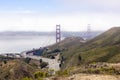 US Highway 101 crossing the Golden Gate Bridge with haze and fog in the Bay. Seen from Slackers Hill on the Marin Headlands Royalty Free Stock Photo