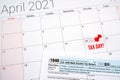 us individual income tax return 1040 form for 2020 with tax day text and red pin on april 15th on april 2021