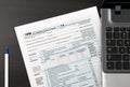 US Individual Tax Return Form 1040 on a table with laptop and pen