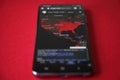 US map of coronavirus confirmed cases on the smartphone screen, red background