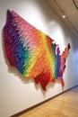 us map made of colorful string art on a white wall