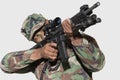 US Marine Corps soldier aiming M4 assault rifle against gray background Royalty Free Stock Photo