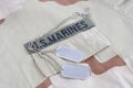 US MARINES branch tape with dog tags on desert camouflage uniform Royalty Free Stock Photo