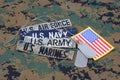 US MILITARY concept with branch tapes and dog tags on camouflage uniform Royalty Free Stock Photo