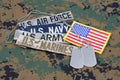 US MILITARY concept with branch tapes and dog tags on camouflage uniform Royalty Free Stock Photo