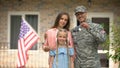 US military man with family showing keys from house, benefits in crediting