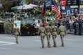 US military men, officers flying flag of USA, marching on a square, crowd of people on a background, military parade