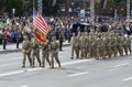 US military men, officers flying flag of USA, marching on a square during military parade dedicated to Day of