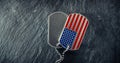 US military soldier`s dog tags, rough and worn with blank space for text, and in the shape of the American flag. Memorial Day for Royalty Free Stock Photo