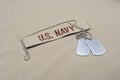 US NAVY branch tape with dog tags on desert camouflage uniform Royalty Free Stock Photo