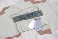 US NAVY branch tape with dog tags with dog tags on desert camouflage uniform Royalty Free Stock Photo