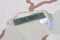 US NAVY branch tape with dog tags with dog tags on desert camouflage uniform Royalty Free Stock Photo