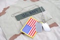 US NAVY branch tape with dog tags and flag patch on desert camouflage uniform Royalty Free Stock Photo