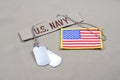 US NAVY branch tape with dog tags and US flag patch on desert camouflage uniform Royalty Free Stock Photo