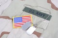 US NAVY branch tape with dog tags and flag patch on desert camouflage uniform Royalty Free Stock Photo