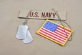 US NAVY branch tape with dog tags and US flag patch on desert camouflage uniform Royalty Free Stock Photo