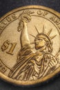 US one dollar $1 coin close-up. Dramatic golden vertical illustration about American money and finance. Expressive aged shot about