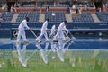 US Open cleaning crew drying tennis court after rain delay at Arthur Ashe Stadium Royalty Free Stock Photo