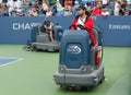 US Open cleaning crew drying tennis court after rain delay at Louis Armstrong Stadium at Billie Jean King National Tennis Center Royalty Free Stock Photo