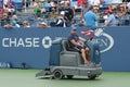 US Open cleaning crew drying tennis court after rain delay at Louis Armstrong Stadium at Billie Jean King National Tennis Center Royalty Free Stock Photo