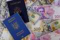 US Passport and ukrainian biometric passpor of US dollar money and ukrainian money hryvnia of dual citizens Royalty Free Stock Photo