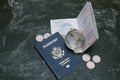 US passports and small glass globe on black background