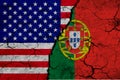 US and Portuguese flag on textured cracked ground. The concept of cooperation between the two countries. 3d rendering Royalty Free Stock Photo