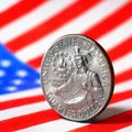 US quarter dollar coin with drummer close-up and USA flag. Stars and stripes in the blur. Beautiful square illustration of Royalty Free Stock Photo
