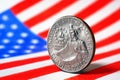 US quarter dollar coin with drummer close-up and USA flag. Stars and stripes in the blur. A vivid illustration of American Royalty Free Stock Photo