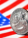 US quarter dollar coin with drummer close-up and USA flag. Stars and stripes in the blur. A vivid vertical illustration of Royalty Free Stock Photo