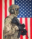 US soldier with machine gun in hands and American flag on background Royalty Free Stock Photo