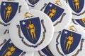 US State Buttons: Pile of Massachusetts Flag Badges 3d illustration