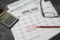 2023 US tax day calendar reminder with tax forms calculator and glasses.