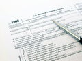 US tax form 1065 with a silver pen