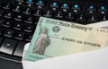 Illustration of the federal stimulus payment check from the IRS on keyboard Royalty Free Stock Photo