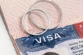 US visa and wedding rings on the passport as a symbol of international marriage