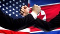US vs North Korea confrontation countries disagreement, fists on flag background