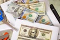 Usa american dollar money bills spread around with ablue scissors close them Royalty Free Stock Photo